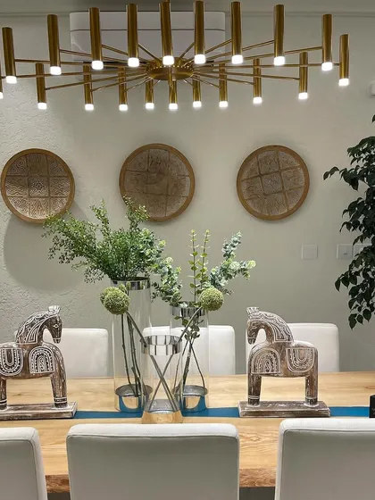 An elegant dining space designed for both comfort and style. Details like the modern chandelier and tasteful decor are what make a house feel like a high end home.