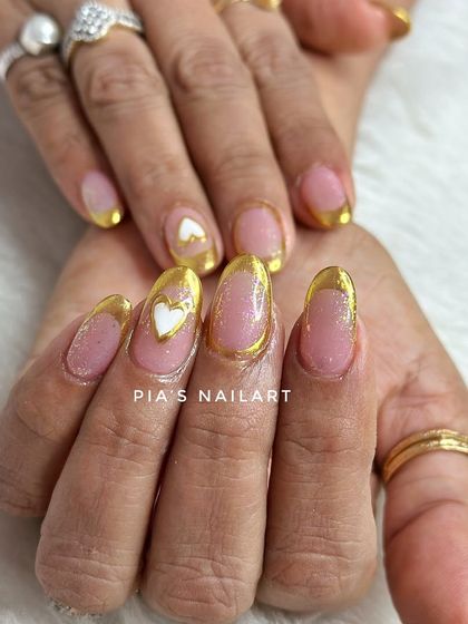 A beautiful combo of gold chrome French tips with delicate white heart accents.