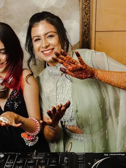 I love being part of special moments. Here I am sharing a laugh with the bride at her sangeet, making sure her big day has the perfect soundtrack.