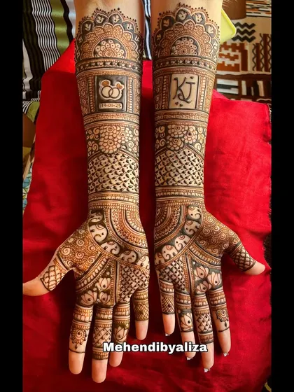 A beautiful engagement henna design with the couple's initials and engagement rings motif. The patterns are a lovely mix of traditional and modern styles.