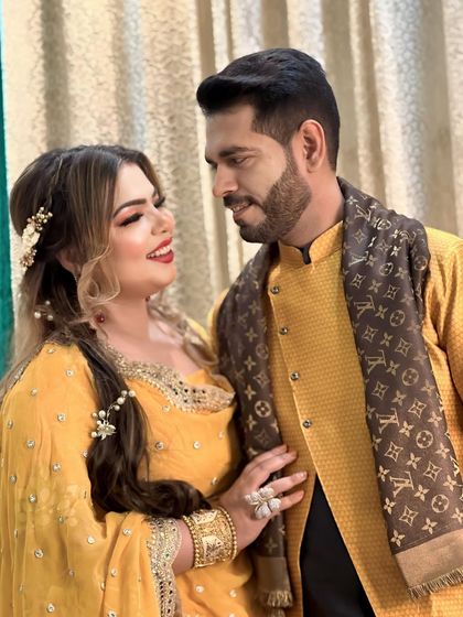 A lovely couple portrait from a Mehendi or Sangeet event. The bride is glowing in her yellow outfit.