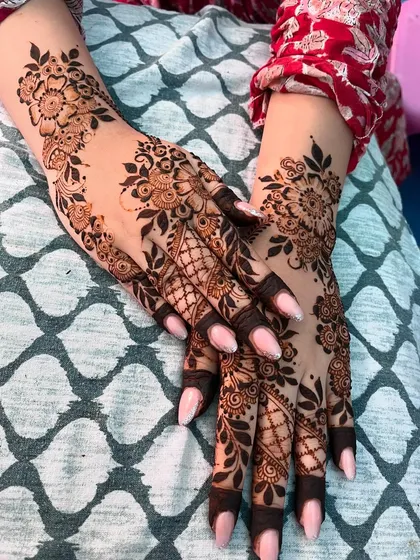 Another pose showcasing the delicate Arabic mehendi, a popular choice for engagement parties and other celebrations.