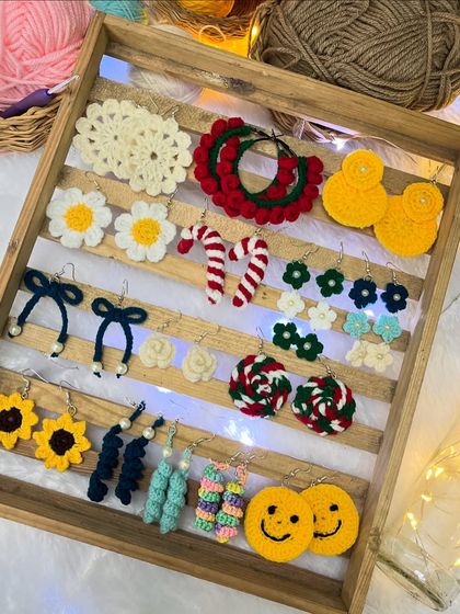 Here is a tray showcasing the wide variety of earrings I can make. From smiley faces and candy canes to daisies and sunflowers, there's a design for every personality.