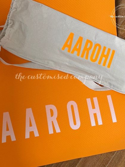 Find your motivation with a personalized yoga mat and matching cover. This bright orange set, customized with a name in a bold font, is sure to bring energy to any workout session.