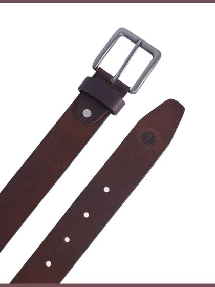 A detail shot of the belt tip and buckle, showing the material and branding.