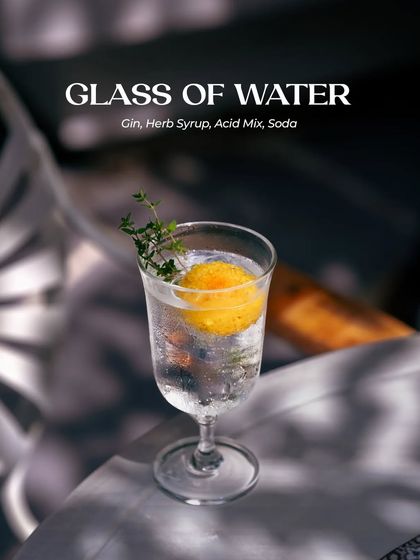 Our "Glass of Water" cocktail, a simple name for a complex and refreshing concoction of gin, herb syrup, acid mix, and soda.