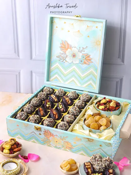 A large, luxurious hamper box filled with dates and other dry fruits. The elegant design and sheer size of the box make it an impressive gift, and the photo captures that perfectly.