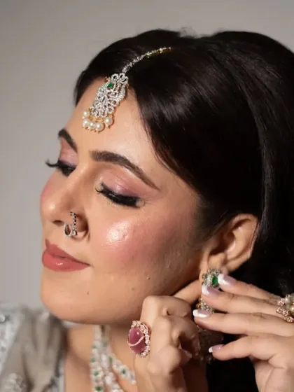 A beautiful close-up of the client's makeup for her reception. The look is glamorous yet sophisticated, with perfectly blended eyeshadow and a radiant finish on the skin.