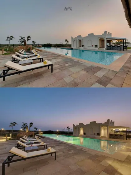 The poolside area at The Fern Sattva Resort at dusk. The design creates a tranquil atmosphere for relaxation, with clean lines and subtle lighting that complement the natural surroundings.