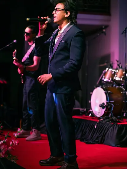 A full-stage view of Abhijeet Sawant performing in our rental tuxedo, showing how it looks in action. Perfect for making a memorable entrance.
