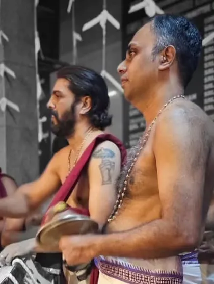 A candid shot of our Ilathalam artists during the Mandala Masam festival, their focus unbroken amidst the celebration.