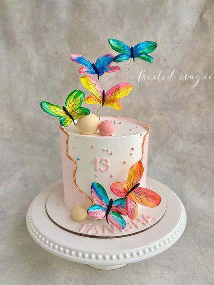 Another take on the butterfly theme, this time for a 13th birthday. The hand-painted wafer paper butterflies seem to fly off the cake, creating a light and airy design perfect for a teenager.