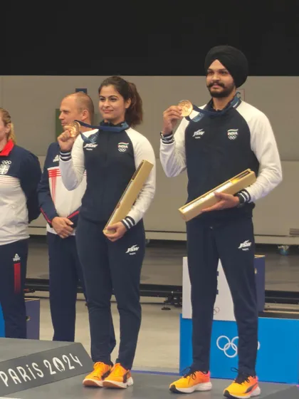 Manu Bhaker and Sarabjot Singh displaying their Olympic bronze medals. This win in the 10m Air Pistol Mixed Team event highlights our expertise in coaching for both individual and team events.