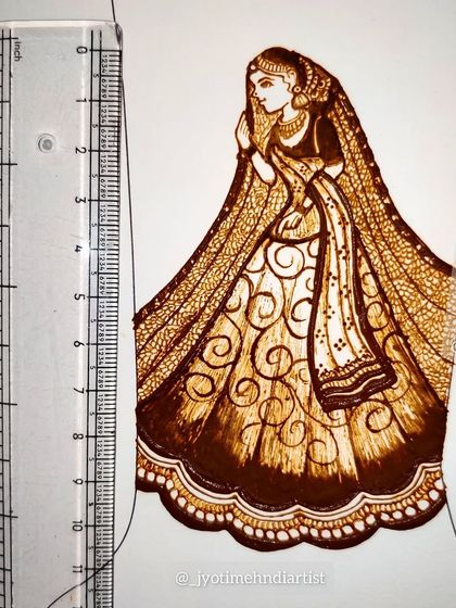 A view of the bridal figure sketch next to a ruler to show the scale and precision of the work.