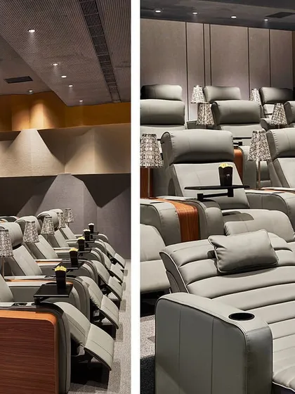 A closer look at the theater seating, which includes plush recliners and chaise lounges with individual side tables and lamps.