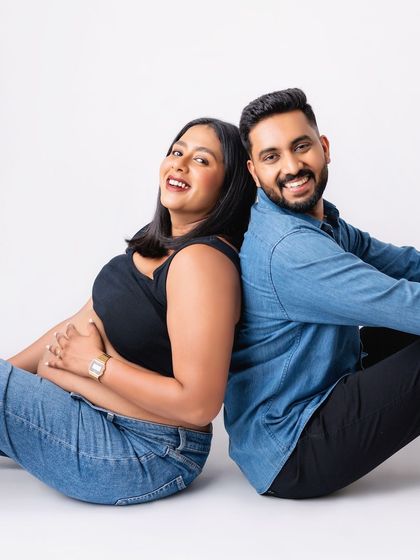 A joyful couple's portrait from a modern maternity shoot. Their smiles say it all.