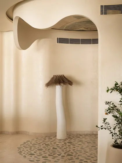 This coffee corner is an ode to our client's love for coffee. The floor features quartzite chips inlaid in a terrazzo pattern, while a sculptural floor lamp and art on the ceiling complete this unique, cozy nook.