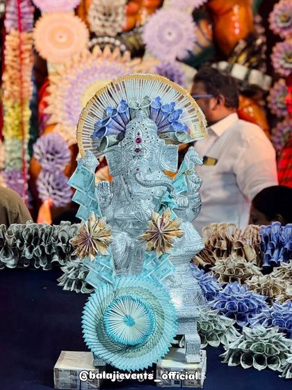 This silver Ganesha idol was part of the larger currency note decoration, adorned with its own delicate flowers made from currency. It shows how I can integrate multiple elements and idols into a cohesive theme.