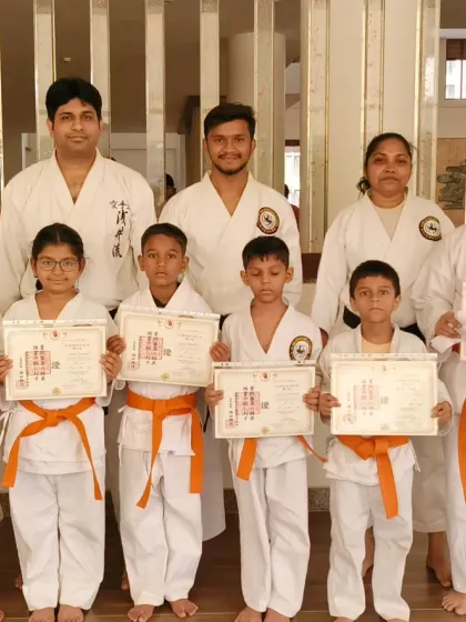 Our instructors with a group of new orange belts at the Virar Branch belt and certificate distribution.