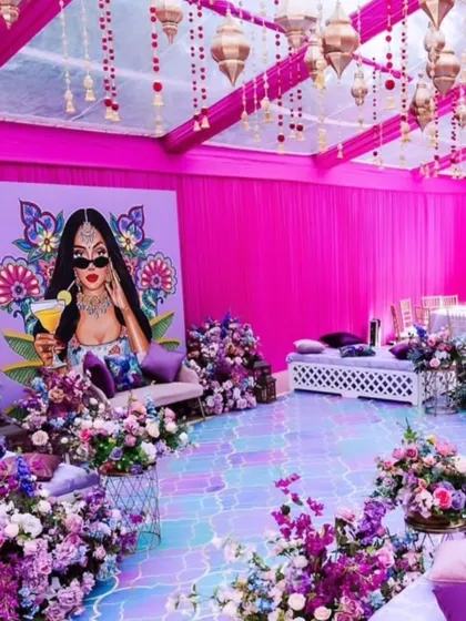 For a fun and modern Mehendi, I created this pop-art themed setup. It includes vibrant pink draping, a custom illustrated backdrop for photos, and colorful low seating with cushions for a relaxed vibe.