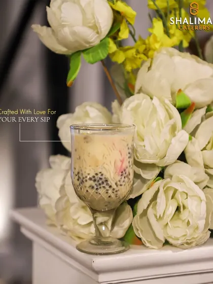 Crafted with love for your every sip. Another elegant shot of our classic Falooda, presented beautifully against a floral background.