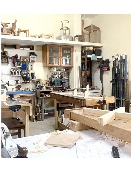 A wide shot of the workshop. It's a space designed for creativity, with tools organized on the walls and workbenches ready for the next project.
