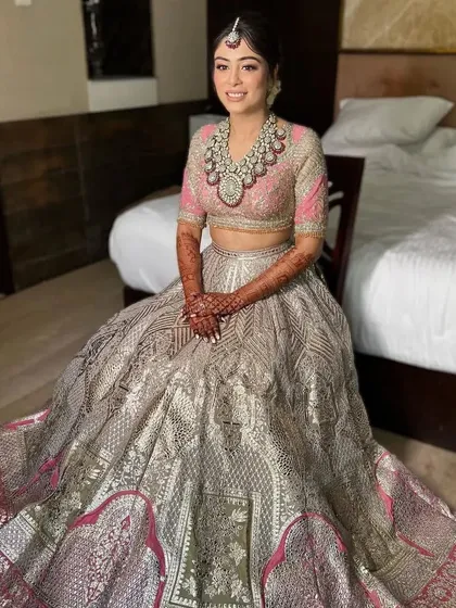 A full-length view of a bride with a soft updo, showing how the hairstyle complements her elaborate bridal gown. It's an elegant choice for a grand wedding.