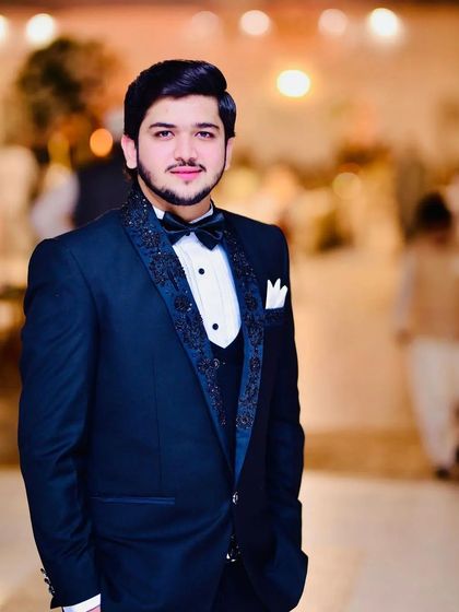 A classic tuxedo for a grand reception. The detailed lapels add a touch of modern flair to this timeless outfit.