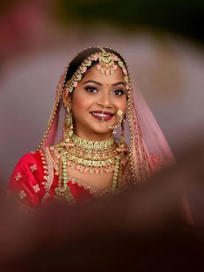 A beautiful close-up from a pre-bride shoot, designed as a trial run for the wedding day look. This portrait uses a creative framing technique to draw focus to the bride's happy expression and flawless makeup.