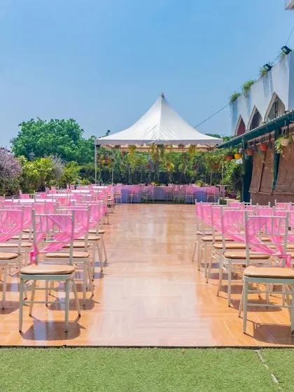 The aisle view of the Terrace Garden, showcasing the clean wooden walkway and neat rows of chairs ready for guests.