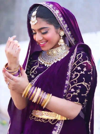 The bride adjusting her bangles, a candid moment that feels natural and beautiful.