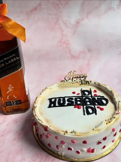 A perfect cake for the husband who loves his whiskey. This custom cake, made for a Valentine's celebration, is paired with a bottle of Johnnie Walker Black Label, featuring a fun crossword design on top.