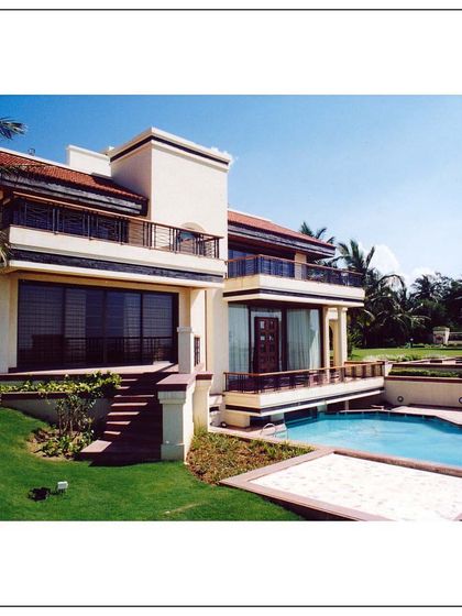 Another perspective of the Daman villa, showcasing the relationship between the building, the pool, and the lawn. The design provides ample outdoor space for recreation and enjoying the sea view.