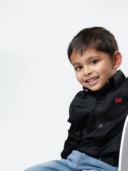 A handsome young man. This simple studio portrait on a white background is clean and classic, focusing entirely on his charming smile.