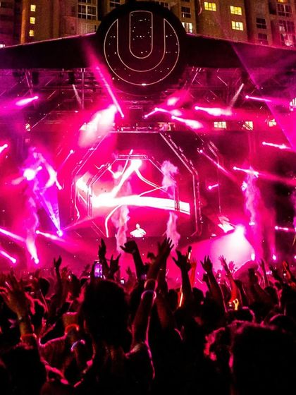 The full Ultra stage lit in pink for KSHMR's set, with thousands of hands in the air, completely immersed in the music.