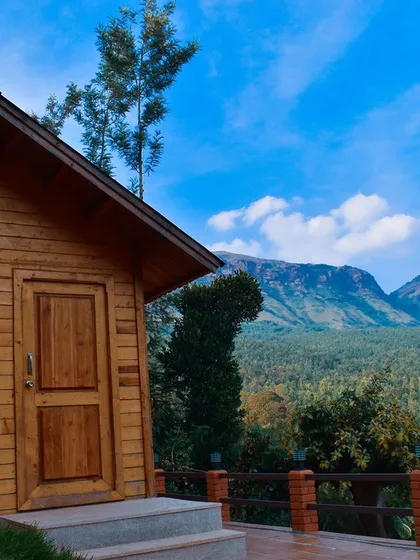 Find your peace in a cozy wooden cottage like this one in Chikmagalur. The stunning view of the Baba Budan Giri mountain range from your porch is the perfect backdrop for a relaxing getaway.