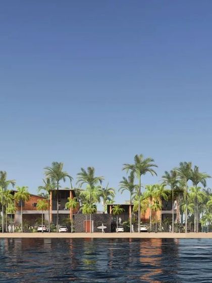 The clean lines of the architecture contrast with the organic forms of the palm trees and the water, creating a balanced composition.