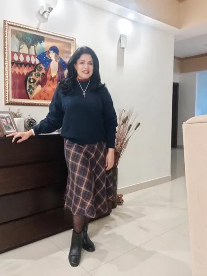 The full outfit before heading out to the party. A tartan skirt is a classic winter piece that is perfect for creating a cozy and festive Christmas look.