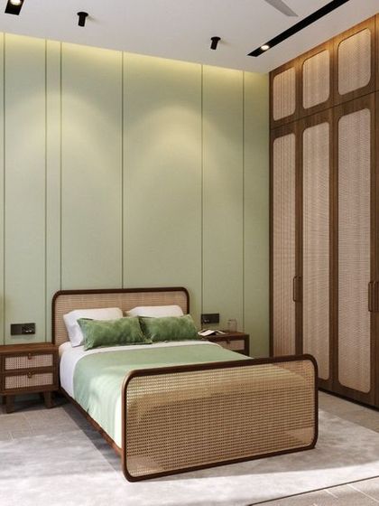 This minimal bedroom interior uses a soft, pastel green accent wall and natural cane furniture to create a fresh and calming atmosphere. The design focuses on clean lines and natural materials, proving that simplicity can be both classy and colorful.