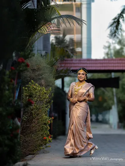 A full-length shot of a model in a beautiful, light-colored silk saree, perfect for a daytime muhurtham ceremony.