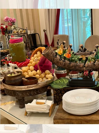 A fun and quirky chaat station setup, complete with decorative figurines, adding a playful touch to the traditional Indian street food experience.