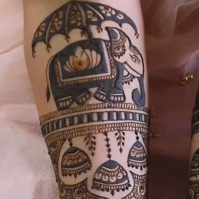 A close up of a majestic elephant motif with an umbrella, a symbol of royalty and celebration.