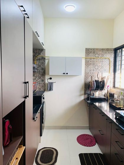 This view shows the utility area and kitchen, designed for maximum efficiency. We ensure every part of the home, including the utility space, is thoughtfully planned for storage and ease of use.