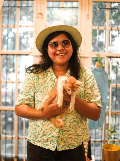 A participant holds a sweet ginger kitten, both looking happy and relaxed.