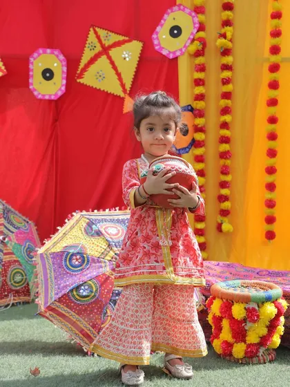 Dressed in her festive best for Baisakhi. This little star is holding a traditional pot, surrounded by the vibrant colors of our Punjabi harvest festival setup.
