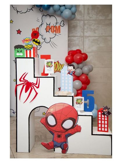 A custom-built prop in the shape of the letter 'H', decorated with a large Spider-Man logo and a chibi Spider-Man cutout.