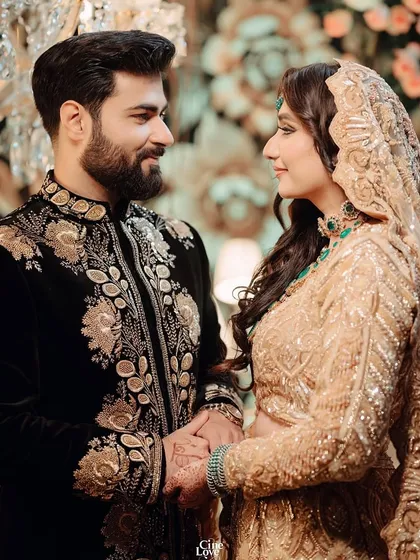 A classic romantic portrait, with the couple looking at each other. Their outfits are styled to create a harmonious and elegant picture.
