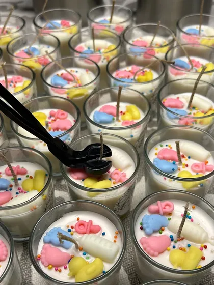 Tiny details, big memories. These are my adorable baby shower shot glass candles, decorated with wax baby feet, bottles, and pacifiers.