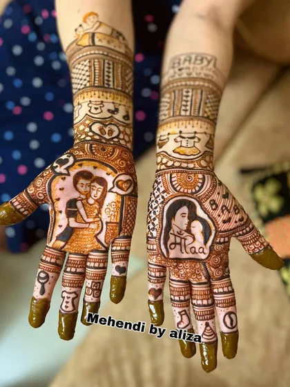 A full baby shower mehendi design with portraits of the couple, the word 'Maa', and other sweet elements celebrating the journey to parenthood.
