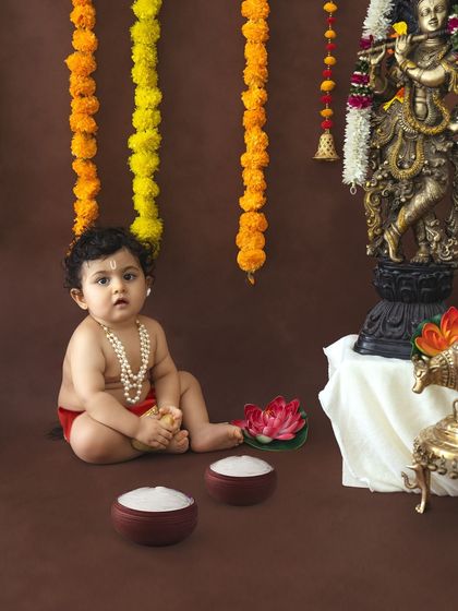 A sweet baby portrait with a focus on the traditional tilak on the forehead and simple pearl necklace.